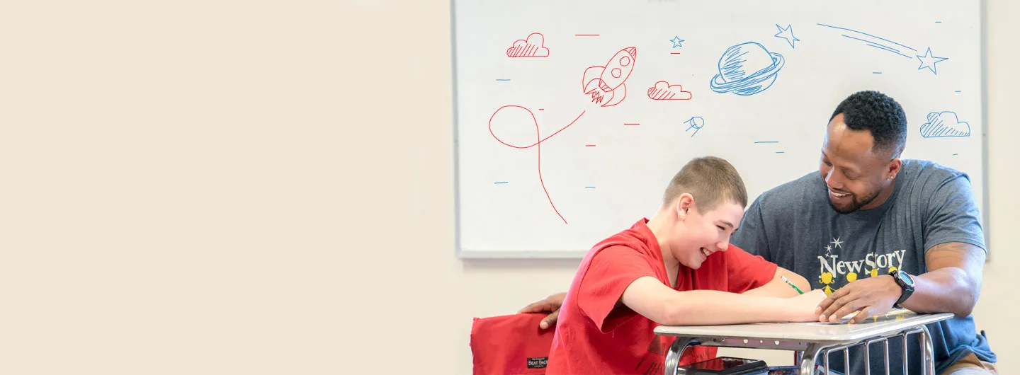 Special Education teacher in school works with middle school student in autism support classroom