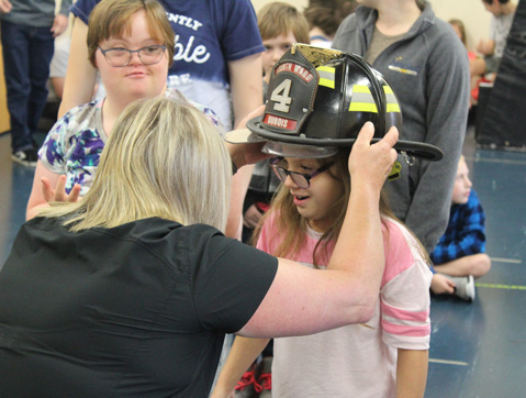 A young girl in an autism support program participates in a fire safety lesson