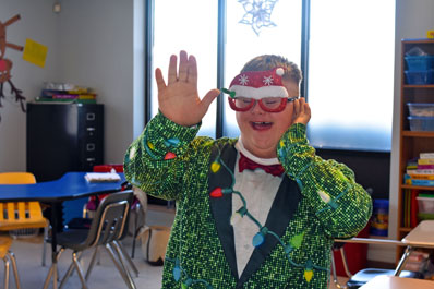A student from an autism support program smiles in a holiday costume
